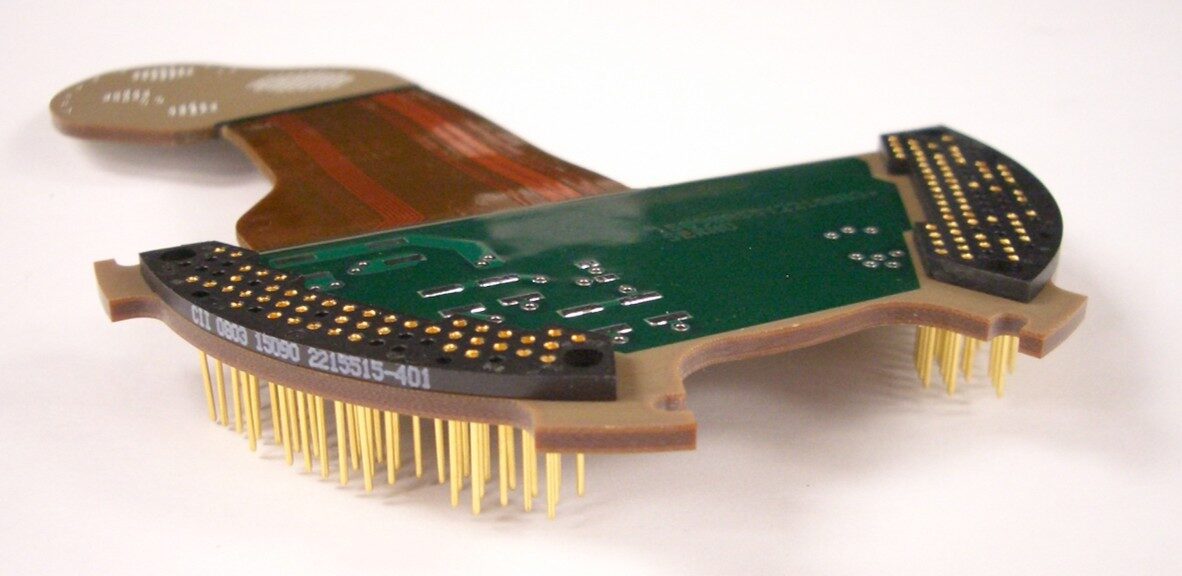 Close-up of a green circuit board with gold pins and connectors.