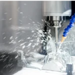 CNC machine cutting metal with coolant spray.