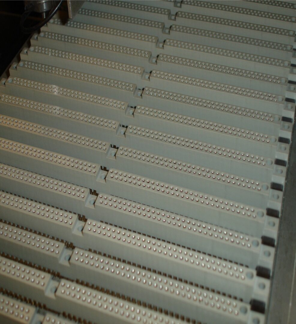Rows of conveyor belt rollers in an industrial setting.