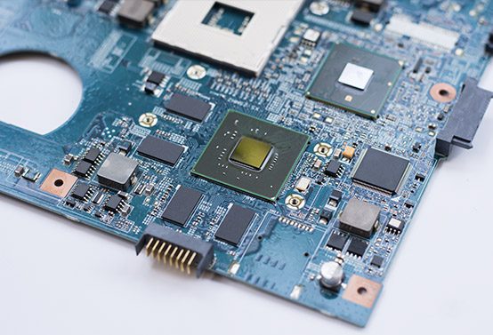 Close-up of a computer motherboard with a central chip and various components.